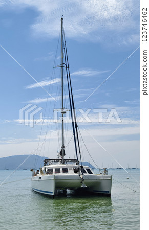 A beautiful white sailing boat gracefully through the water A beautiful white sailing boat gracefully through the water 123746462