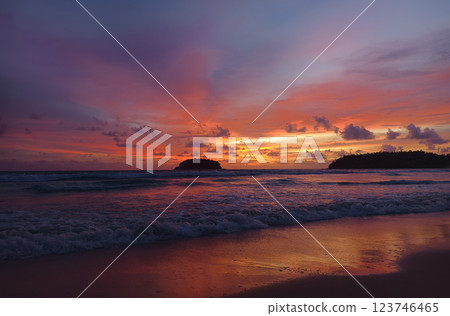 A stunning sunset is casting vibrant hues of color over a tranquil ocean A stunning sunset is casting vibrant hues of color over a tranquil ocean 123746465