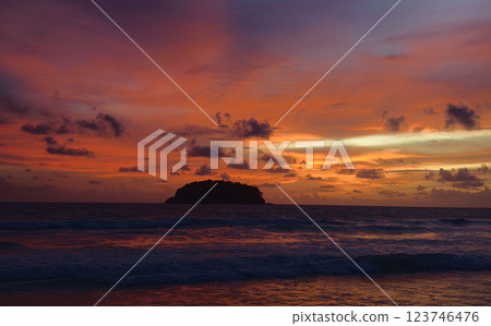A stunning sunset is casting vibrant hues of color over a tranquil ocean A stunning sunset is casting vibrant hues of color over a tranquil ocean 123746476