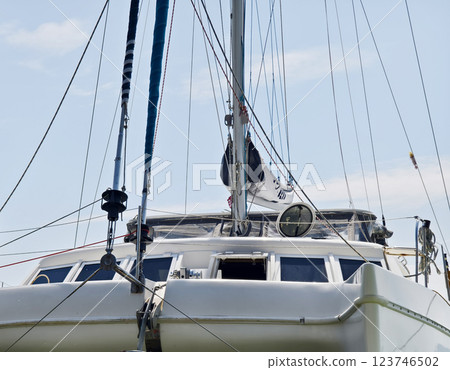 A white voyage boat featuring a steering wheel floating in the water 123746502
