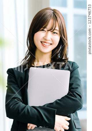 Smiling woman/businesswoman with a laptop Smiling woman/businesswoman with a laptop 123746753