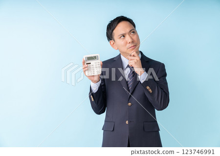 Man holding a calculator Business trouble Man holding a calculator Business trouble 123746991