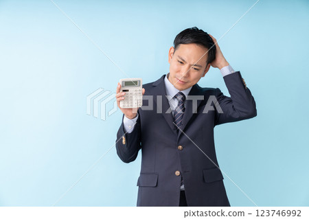 Man holding a calculator Business trouble 123746992