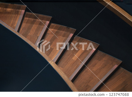 Layered wood spiral stairs with railings handle grip interior. Layered wood spiral stairs with railings handle grip interior. 123747088