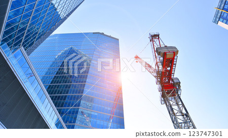 Crane on the construction site in a site surrounded by the high buildings. 123747301