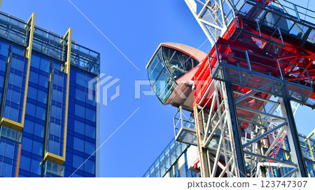 Crane on the construction site in a site surrounded by the high buildings. Crane on the construction site in a site surrounded by the high buildings. 123747307