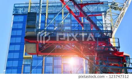 Crane on the construction site in a site surrounded by the high buildings. Crane on the construction site in a site surrounded by the high buildings. 123747312