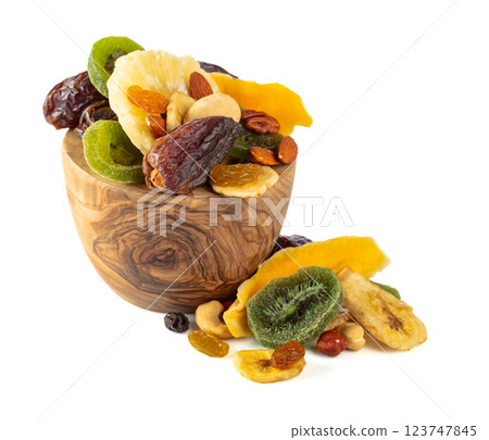 Dried tropical fruits, nuts, and raisins isolated on white. Dried tropical fruits, nuts, and raisins isolated on white. 123747845