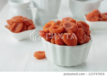 Organic dried apricots on a white table. 123747859
