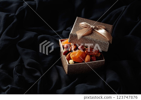 Dried fruits and nuts in a gift box. 123747876