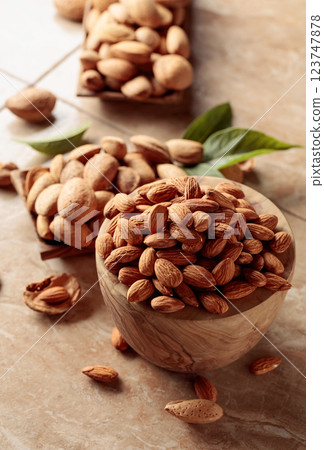 Almond nuts in a wooden bowl. 123747878