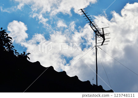Yagi antenna towering on the roof 123748111
