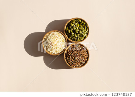 Pumpkin, Flax and Sesame Seeds in Bowls. Organic Superfood Trio. Pumpkin, Flax and Sesame Seeds in Bowls. Organic Superfood Trio. 123748187