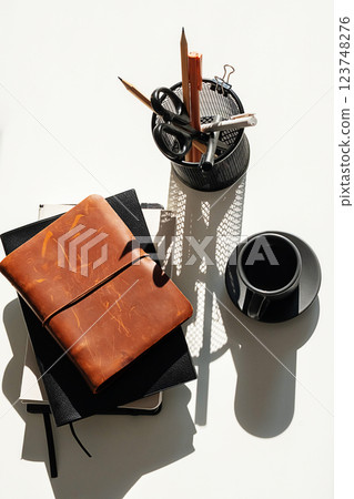 Office Objects and Coffee Cup Arranged on White Desk. Office Objects and Coffee Cup Arranged on White Desk. 123748276