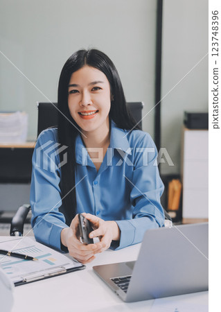 Entrepreneur Asian businessman and businesswoman discussing new business project in tablet in modern Meeting In Modern Office, Asian business casual concept. 123748396