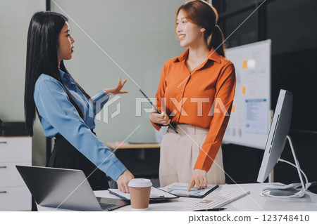 Entrepreneurs and business people conference in modern meeting room, happy multiracial coworkers have fun cooperating working together at office meeting, asian teamwork concept 123748410