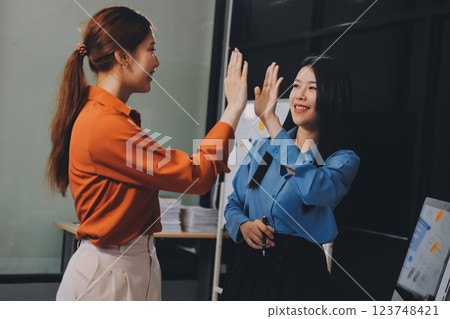 Portrait happy two young asian businesswoman standing with confident together in office, happiness two business woman arms crossed with success, coworker and friendship, business and team. Portrait happy two young asian businesswoman standing with confident together in office, happiness two business woman arms crossed with success, coworker and friendship, business and team. 123748421
