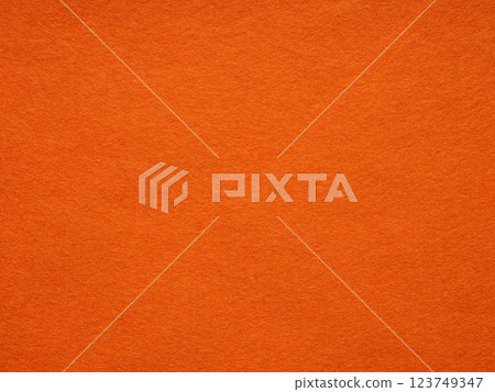 Sunset hues dance on a plush orange felt texture, inviting warmth and vibrant creativity 123749347