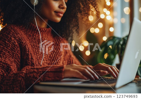 Focused Young Woman Working on Laptop with Headphones 123749693