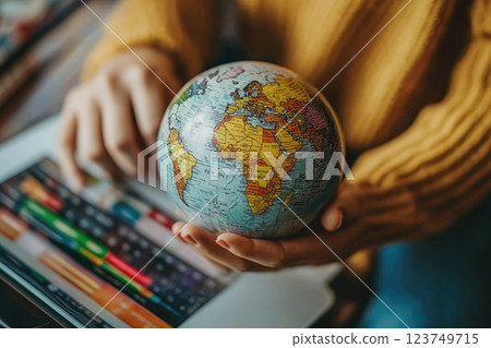A woman is holding a globe on a tablet, Online marketplace with global discounts concept A woman is holding a globe on a tablet, Online marketplace with global discounts concept 123749715