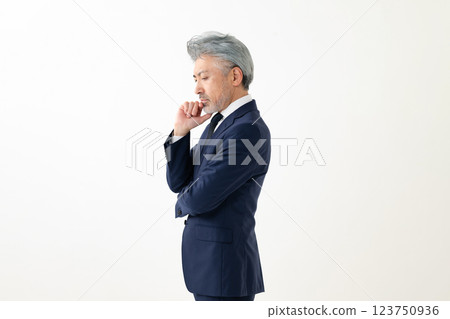 A man hitting his hands on his chin 123750936