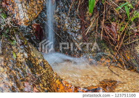 Water flowing down from the rock surface Water flowing down from the rock surface 123751100