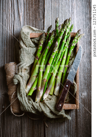 Just picked green asparagus sprouts in a wooden box Just picked green asparagus sprouts in a wooden box 123751145
