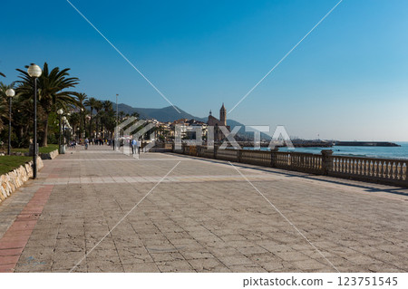 Famous promenade in Sitges, Spain, with palm trees and historic buildings 123751545