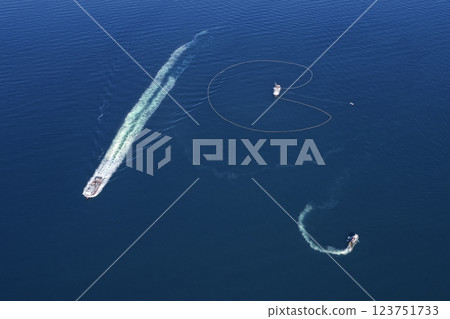 Bird's eye view of a large fishing vessels retrieving its nets.  123751733