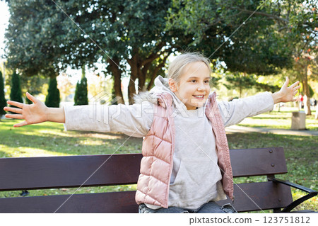 Adorable young girl walking outdoors. Portrait of child 10 years old 123751812