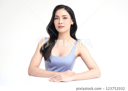 A beautiful young Asian woman with clean, fresh skin against a white background. She represents beauty, skincare, and spa treatments. 123752032