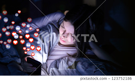 Girl with phone at night, receives hearts and likes. Girl with phone at night, receives hearts and likes. 123752186