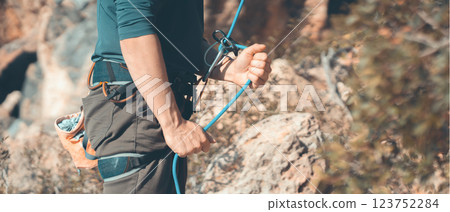 Man is engaged in extreme sports, rock climbing. 123752284