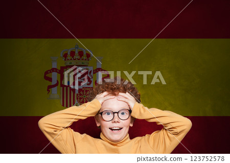 Funny surprised child boy on Spanish flag background. Education and childhood in Spain concept Funny surprised child boy on Spanish flag background. Education and childhood in Spain concept 123752578
