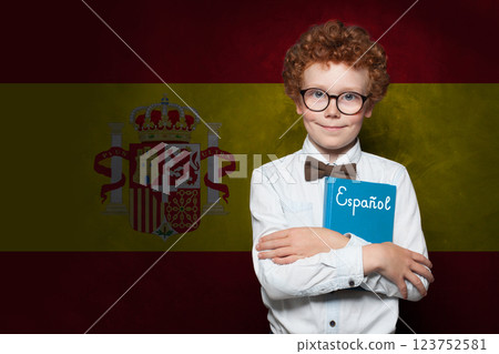 Smiling schoolboy child on Spanish flag background. Education and childhood in Spain concept Smiling schoolboy child on Spanish flag background. Education and childhood in Spain concept 123752581