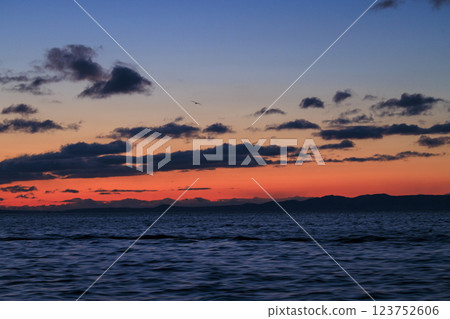 Kunashiri Island shining in the morning glow (taken from off the coast of Rausu) 123752606