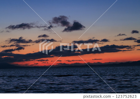 Kunashiri Island shining in the morning glow (taken from off the coast of Rausu) 123752623