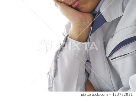 A man in work clothes thinking A man in work clothes thinking 123752951