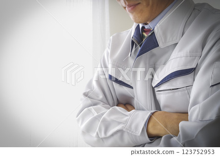 A man in work clothes thinking A man in work clothes thinking 123752953