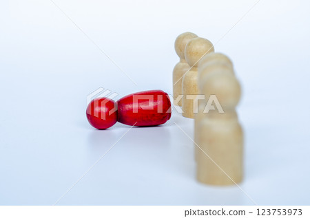 A fallen red wooden doll from the line. Discrimination concept A fallen red wooden doll from the line. Discrimination concept 123753973
