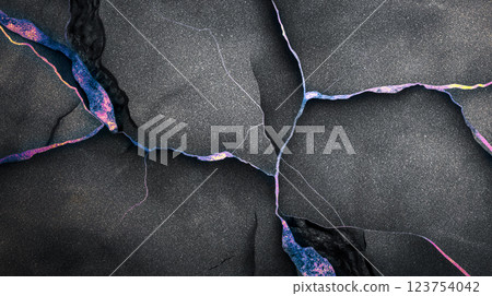 This vibrant abstract background features cracks and lines illuminated with colors, creating a striking visual effect. It showcases a blend of dark and colorful elements. 123754042