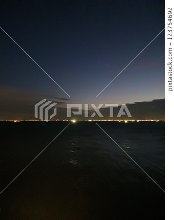 "A fantastic dawn scene interwoven with the sea and city night view" 123754692