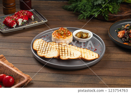 Portion of baked brie with jalapeno and toast 123754763