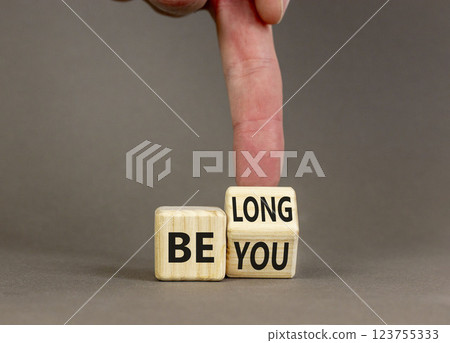 Belonging and belong symbol. Concept words Be you Belong on beautiful wooden block. Beautiful grey background Businessman hand. Business motivational belonging and belong concept. Copy space. Belonging and belong symbol. Concept words Be you Belong on beautiful wooden block. Beautiful grey background Businessman hand. Business motivational belonging and belong concept. Copy space. 123755333