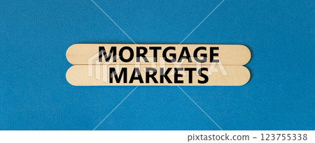 Mortgage markets symbol. Concept words Mortgage markets on beautiful wooden stick. Beautiful blue table blue background. Business mortgage markets concept. Copy space. 123755338