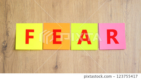 Fear symbol. Concept word Fear on beautiful colored paper. Beautiful wooden table wooden background. Business, lifestyle and fear concept. Copy space. Fear symbol. Concept word Fear on beautiful colored paper. Beautiful wooden table wooden background. Business, lifestyle and fear concept. Copy space. 123755417