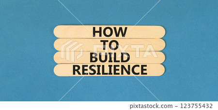 How to build resilience symbol. Concept words How to build resilience on beautiful wooden sticks. Beautiful blue table blue background. Business and how to build resilience concept. Copy space. 123755432