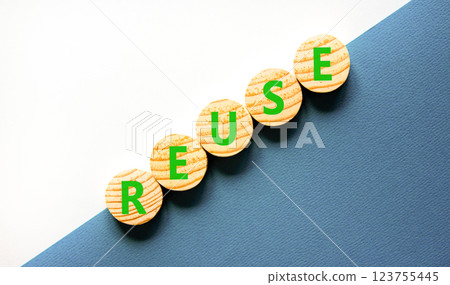 Reuse symbol. Concept word Reuse on beautiful wooden circles. Beautiful white and blue background. Business lifestyle ecological reuse concept. Copy space. 123755445