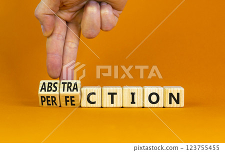 Perfection or abstraction symbol. Concept words Perfection Abstraction on beautiful wooden blocks. Beautiful orange background. Businessman hand. Business perfection or abstraction concept. Copy space Perfection or abstraction symbol. Concept words Perfection Abstraction on beautiful wooden blocks. Beautiful orange background. Businessman hand. Business perfection or abstraction concept. Copy space 123755455