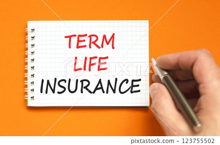 Term life insurance symbol. Concept words Term life insurance on beautiful white note. Beautiful orange background. Businessman hand with black pen. Business term life insurance concept. Copy space. 123755502